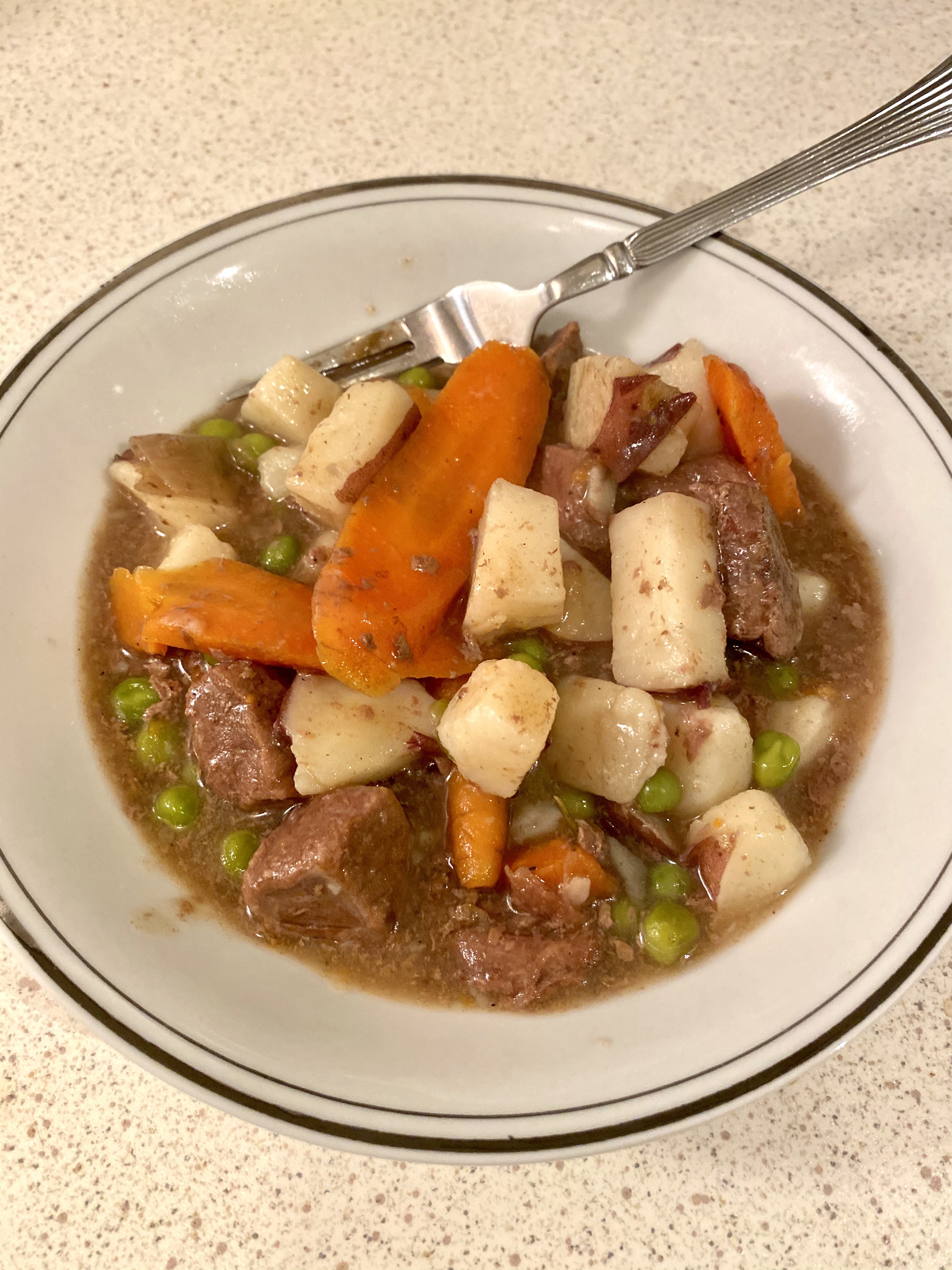 a bowl of deer stew and vegetables