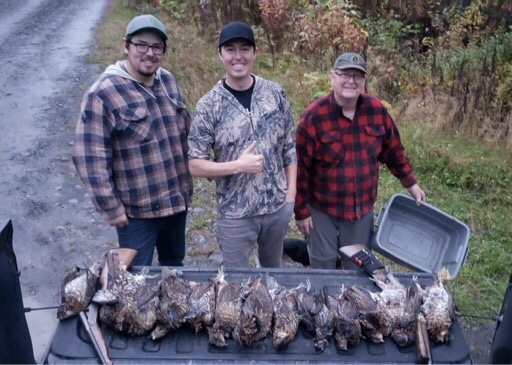 three men with multiple grouse lined up 