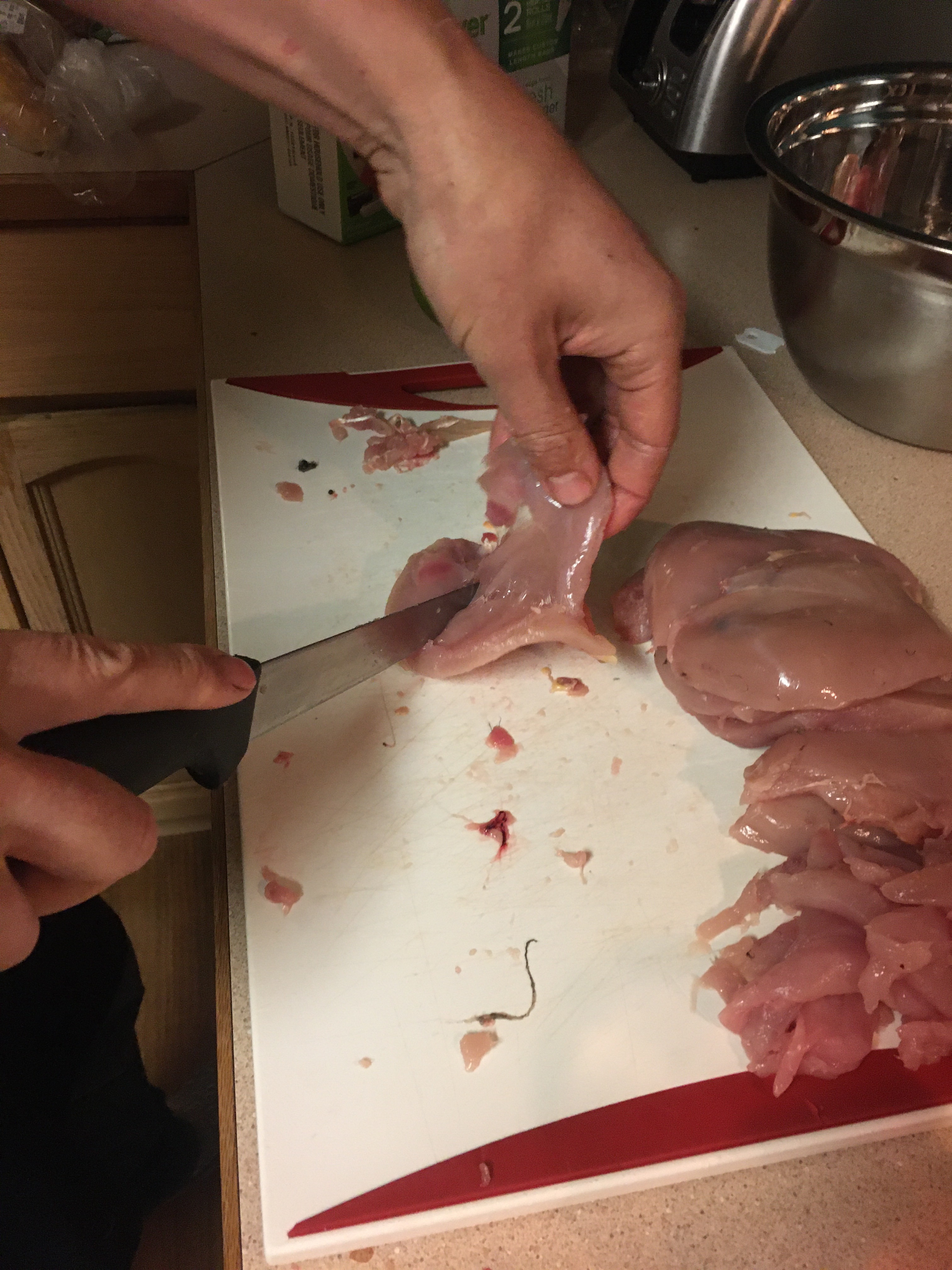 a person cutting the breast bone off