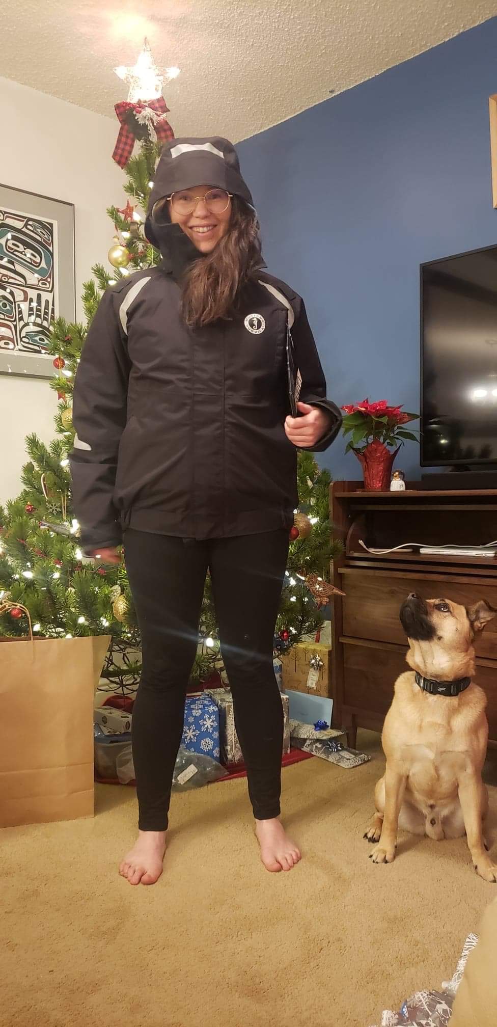 a young lady and a dog in the living room