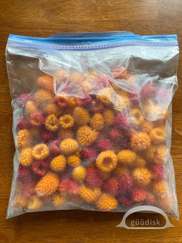 a plastic bag of frozen salmonberries