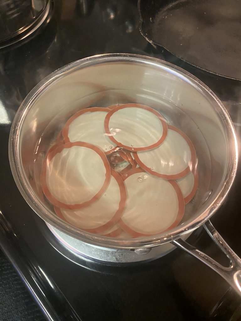 warm up jar lids on the stove